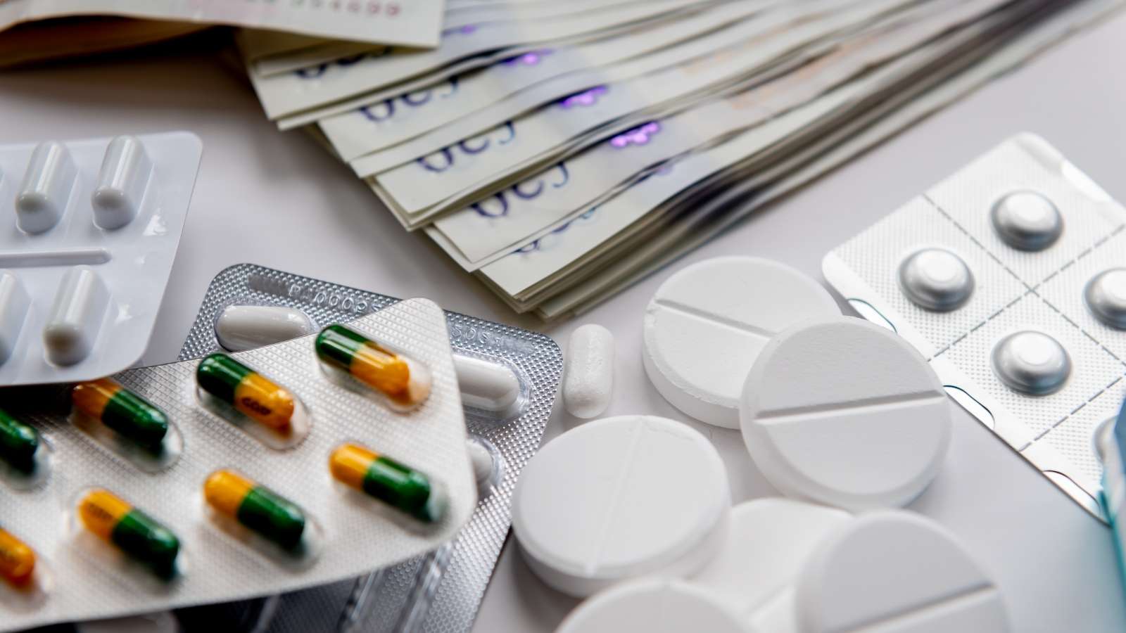 A big pharma concept with medicine and bank notes