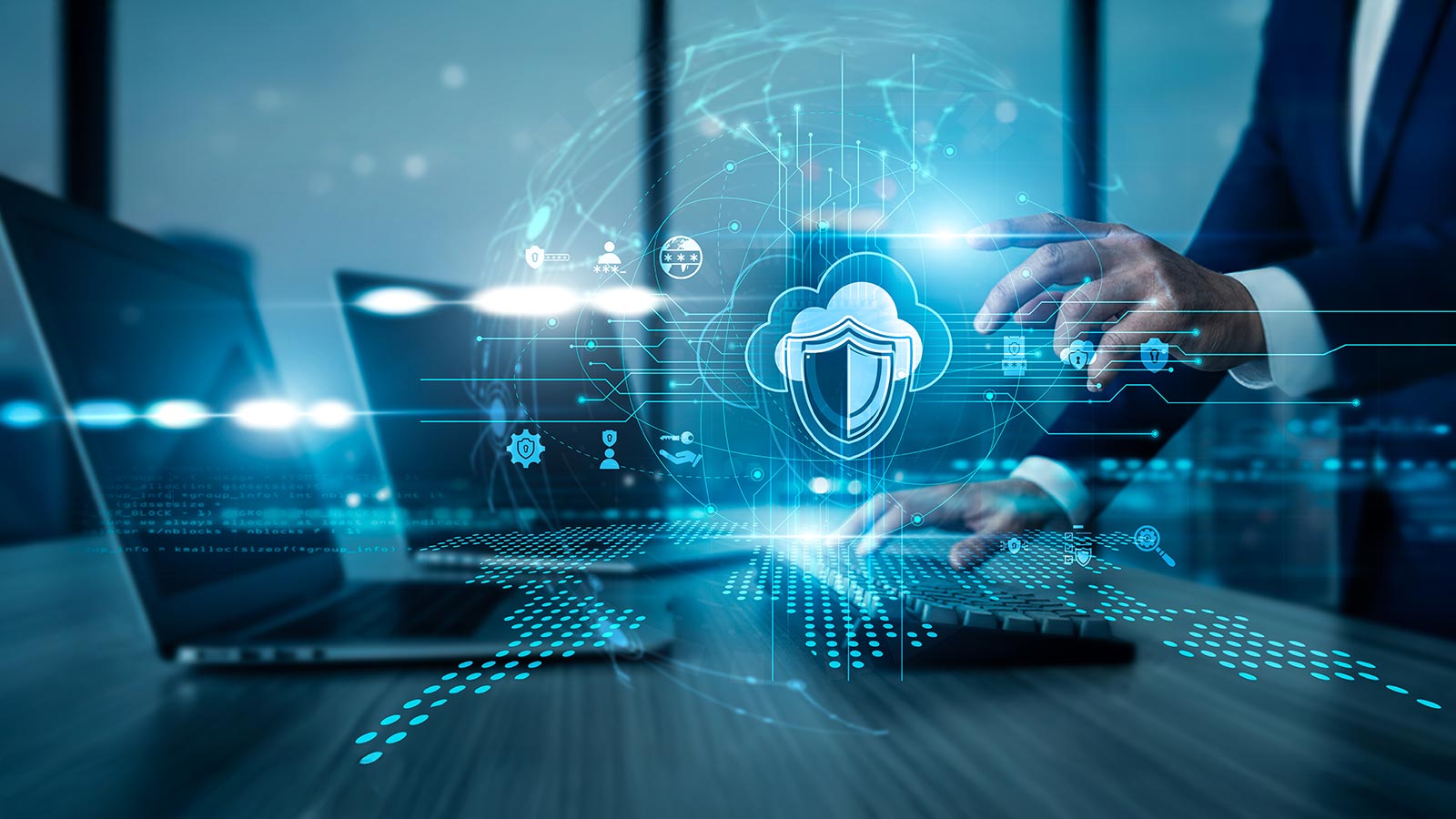 An IT specialist using a laptop with analysis data Cloud Security protecting cloud systems