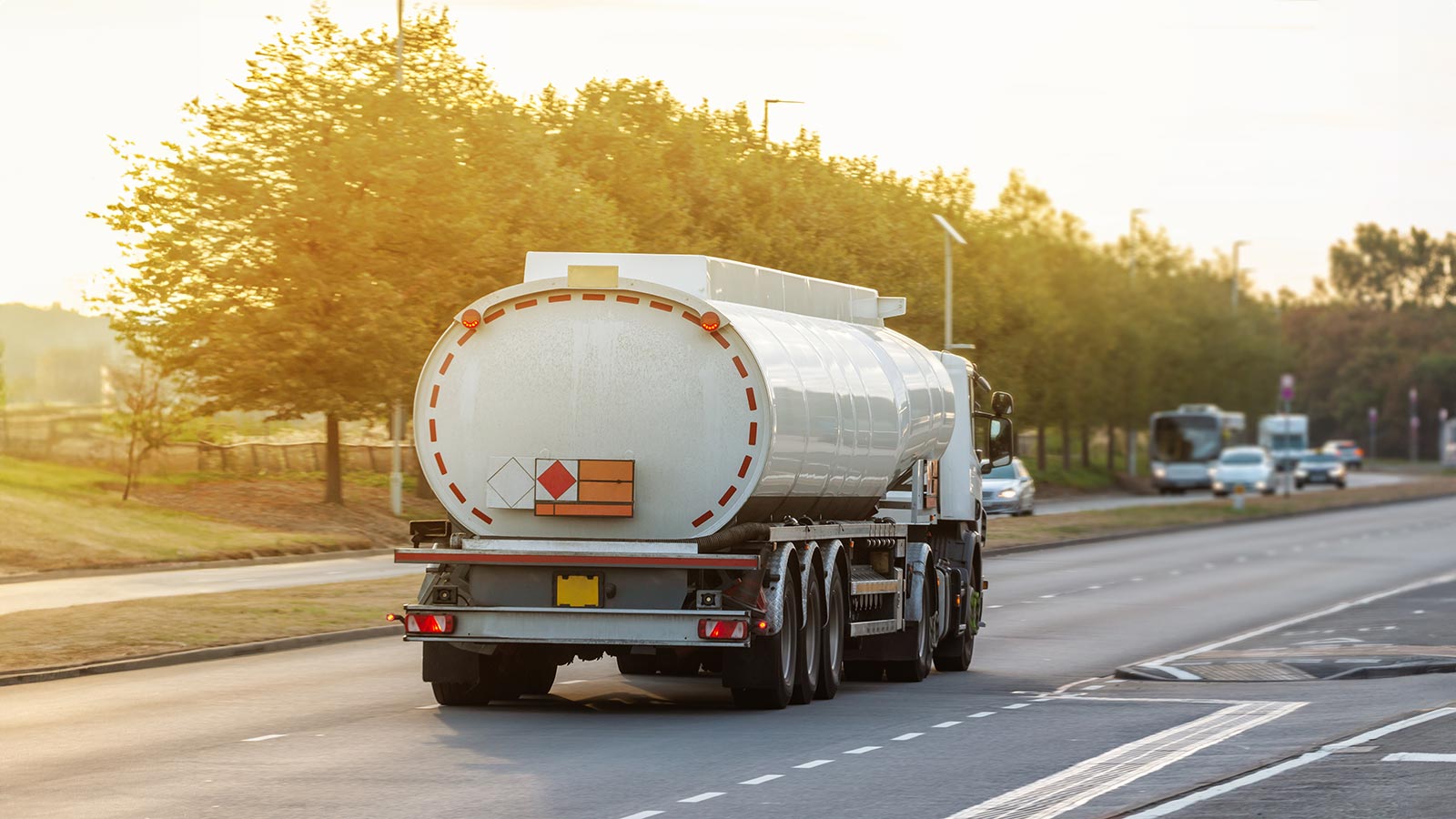 Tanker lorry in motion on the road during sunset