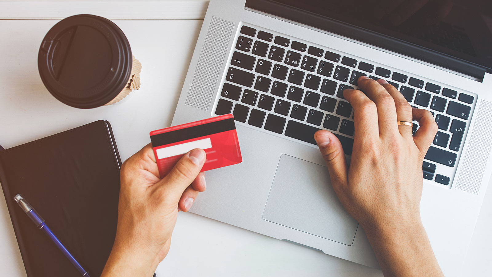 Top view of man using credit card for online shopping