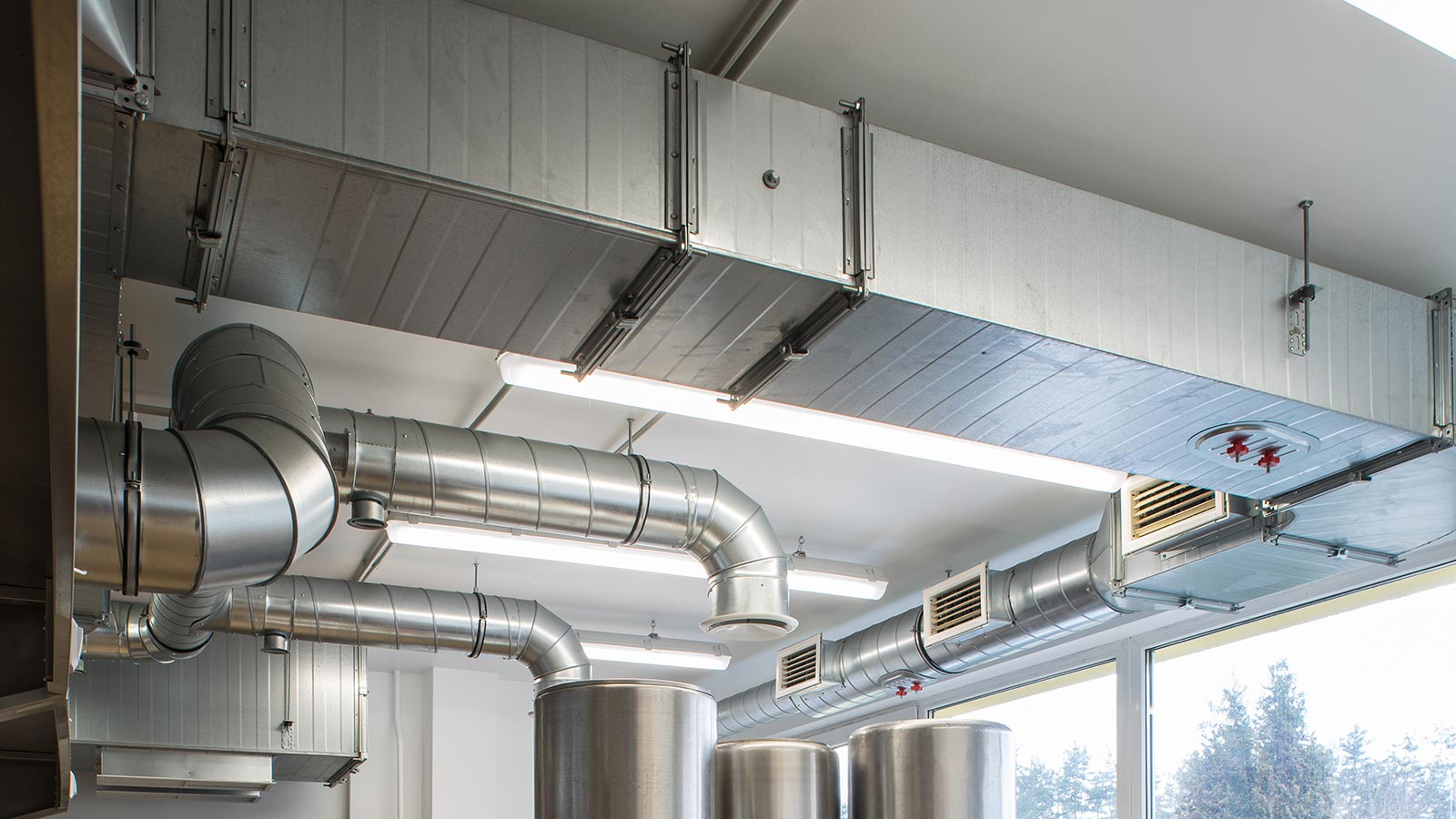 Ventilation pipe system in kitchen interior.