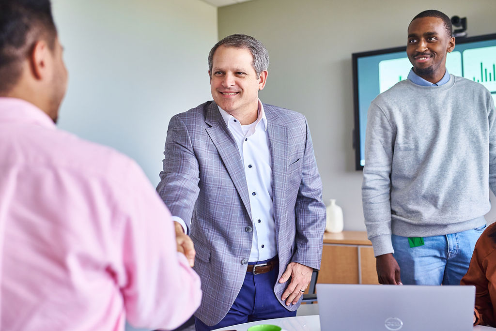 Weaver employees shaking hands after a meeting