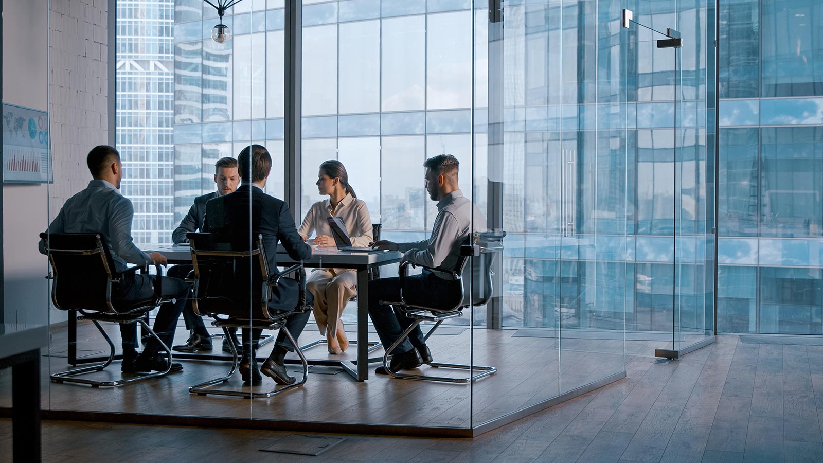 Young business people attending the meeting in boardroom